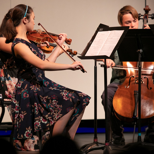 violin and cello being played by students